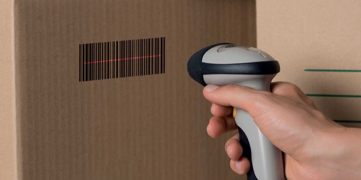 A person uses a barcode scanner to scan a box 