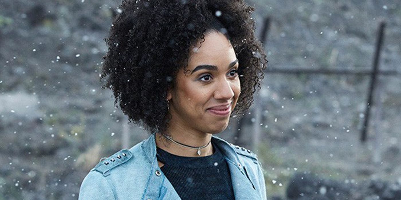Bill Potts smiles while standing in the snow in Doctor Who.