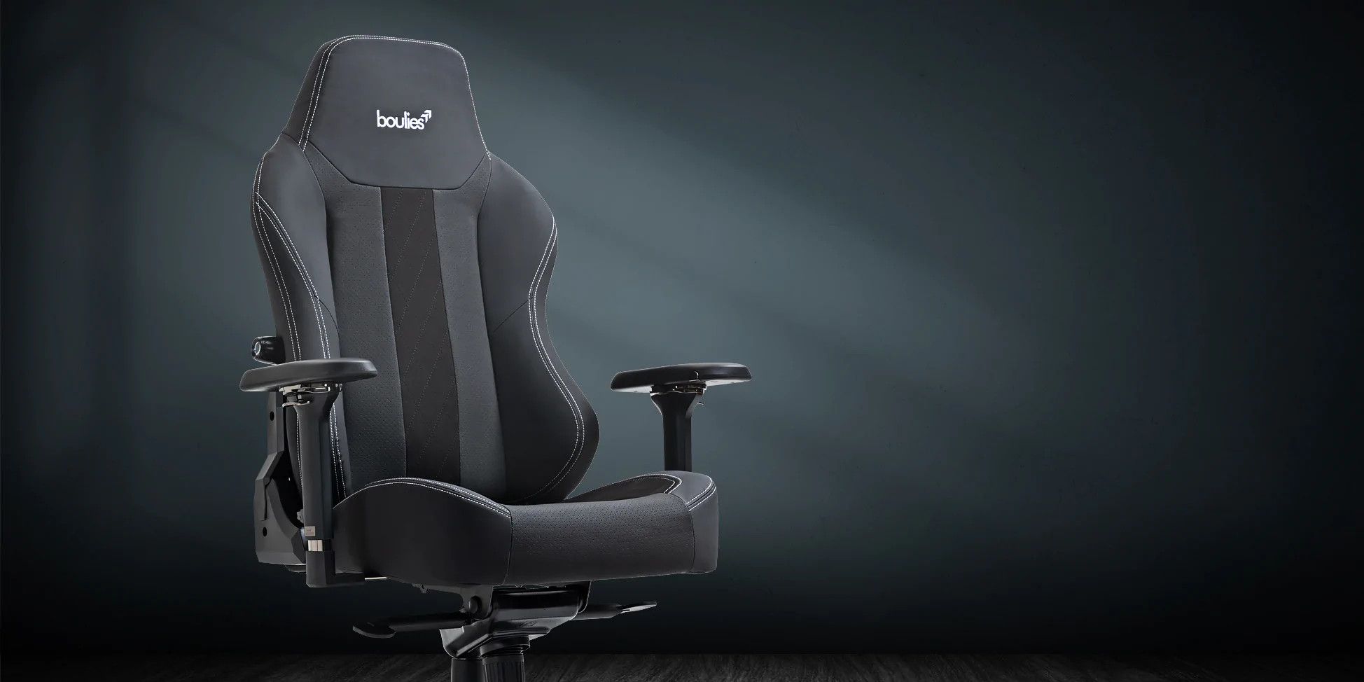 An image of a Boulie's Master Chair at an angle against a black and grey background