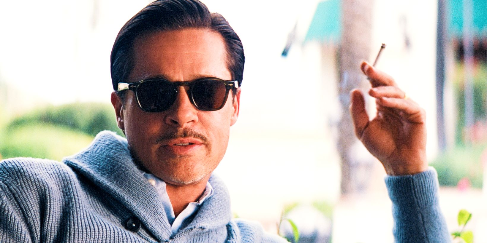 Brad Pitt as Jack Conrad smoking cigarette and wearing sunglasses in Babylon