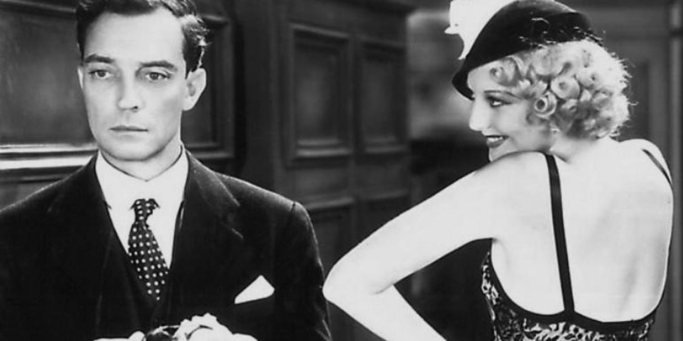 Buster Keaton looking glum while a woman smiles in Speak Easily 