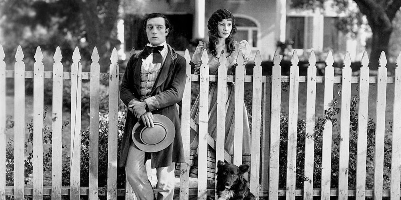 Buster Keaton standing in front of a fence in Our Hospitality 