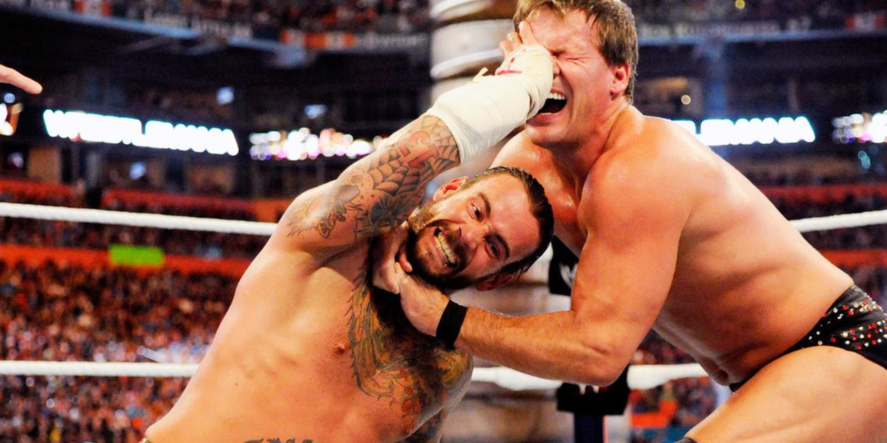 CM Punk thumbs Chris Jericho in the eye during their WrestleMania match in WWE.