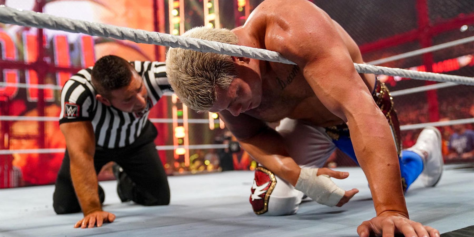 Cody Rhodes gathers himself during his WWE Hell In A Cell match against Seth Rollins in 2022.