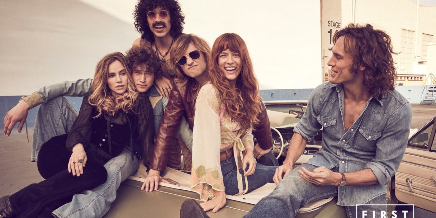 Group photo of rock band members posing on a car wearing 1970s clothes and hairstyles