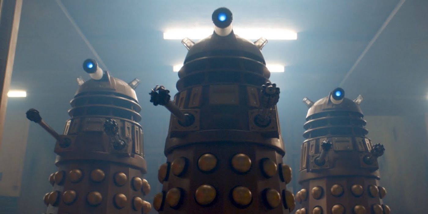 A trio of Daleks roll through a hallway in Doctor Who