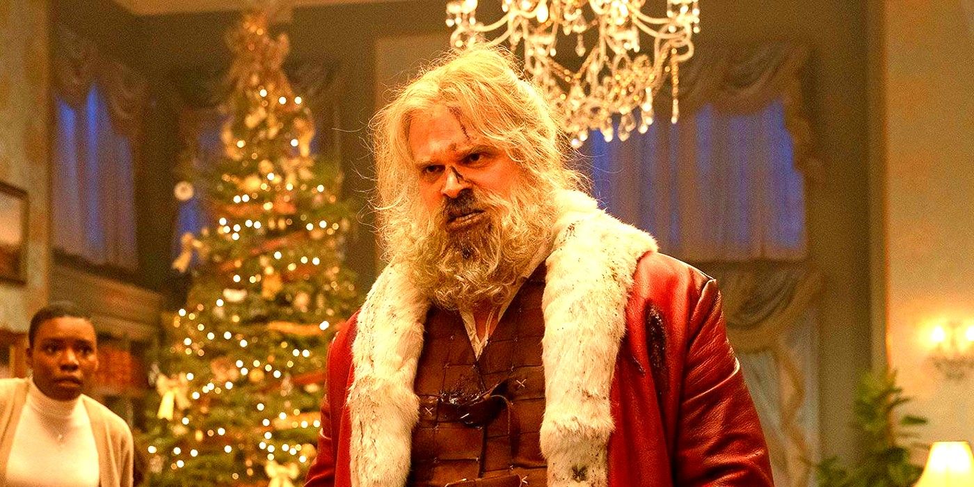 David Harbour as Santawith a bloody nose in front of a Christmas tree in Violent Night