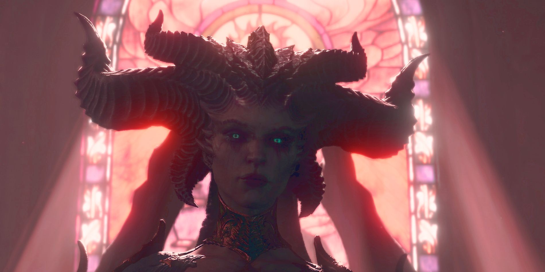 The main villian of Diablo 4, Lilith, is seen looking menicingly towards the screen with light ray shining through a stainglass window behind her.