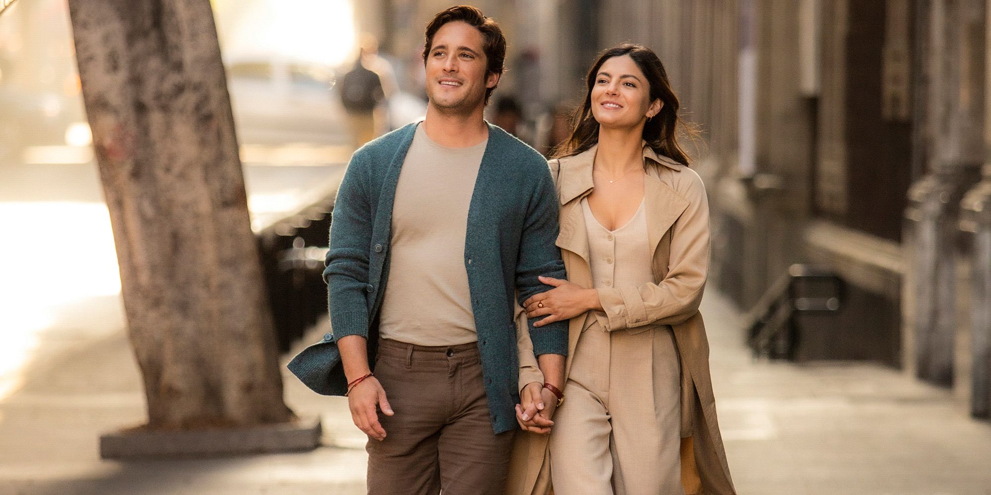 Diego Boneta and Monica Barbaro walking down a street in AT MIDNIGHT on Paramount