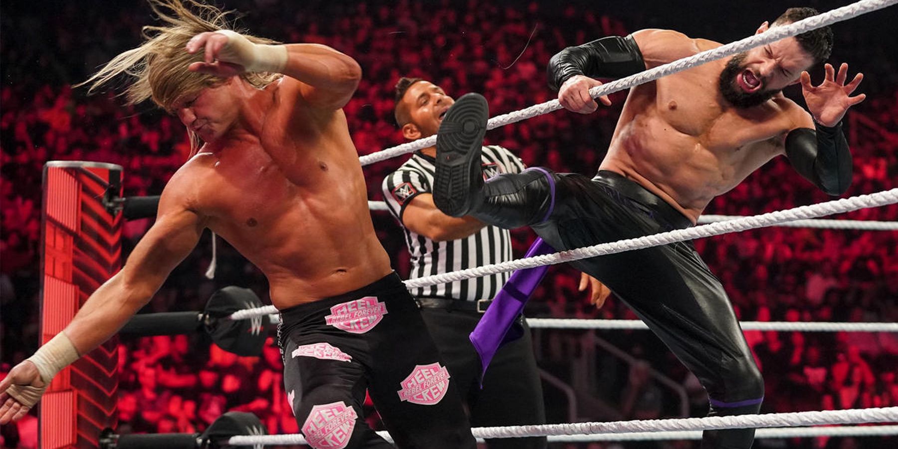 Dolph Ziggler gets booted off of the ring apron by Finn Balor during a match on WWE Raw in 2022.