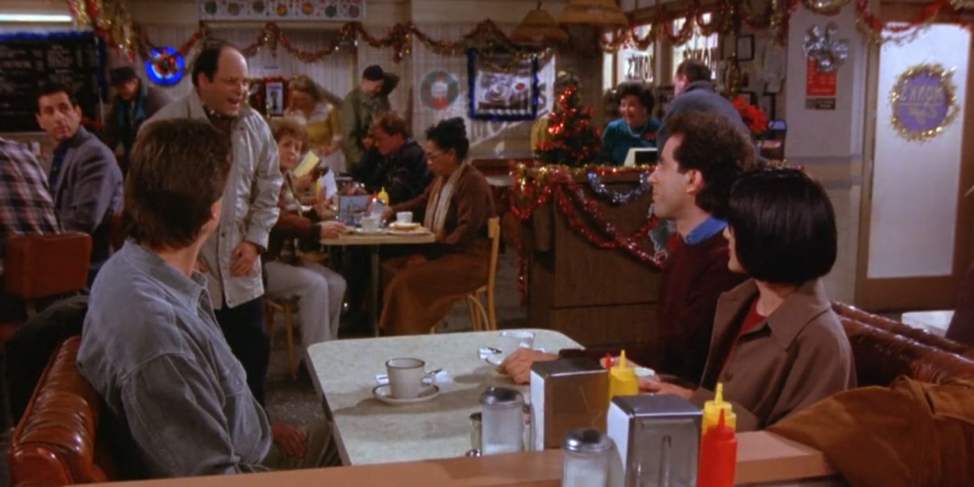 George conversando com Duncan, Jerry e Lois no Monk's Cafe em Seinfeld.
