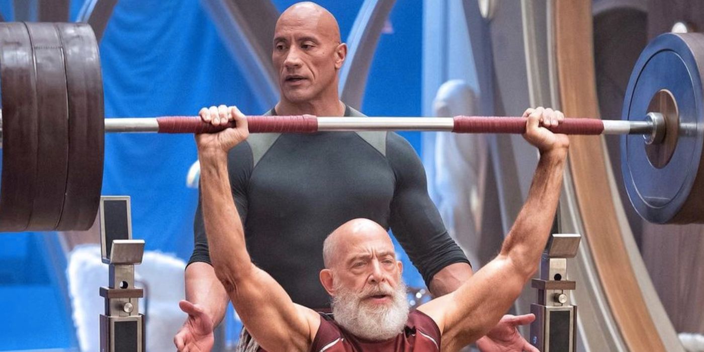 Dwayne Johnson e JK Simmons como Papai Noel levantando pesos no set em Red One