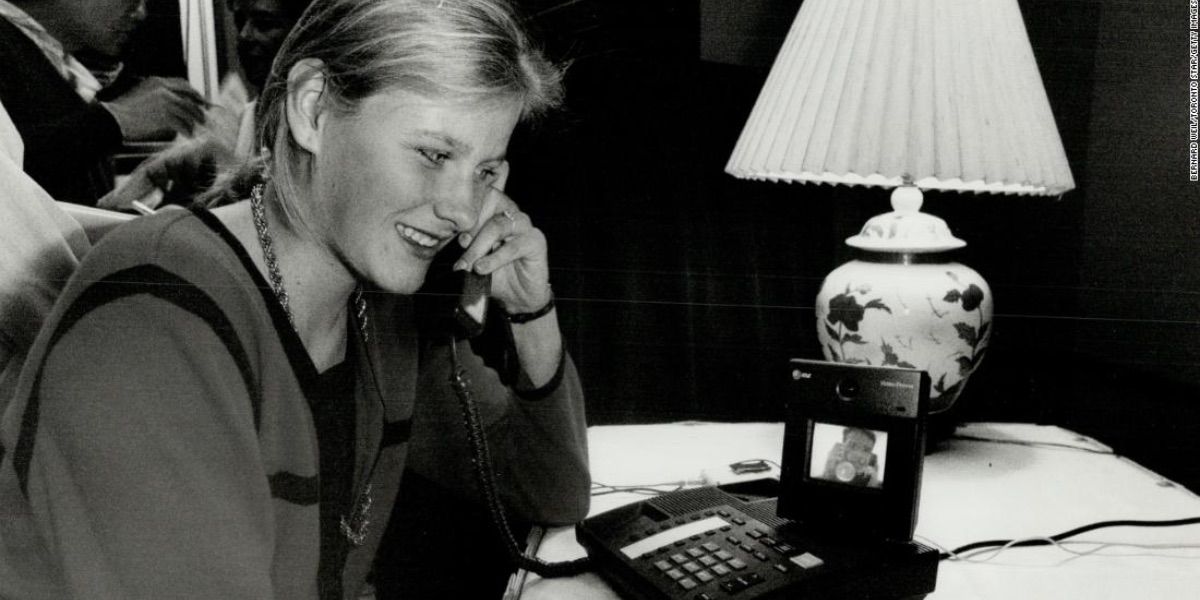 A young woman talks on a video telephone 