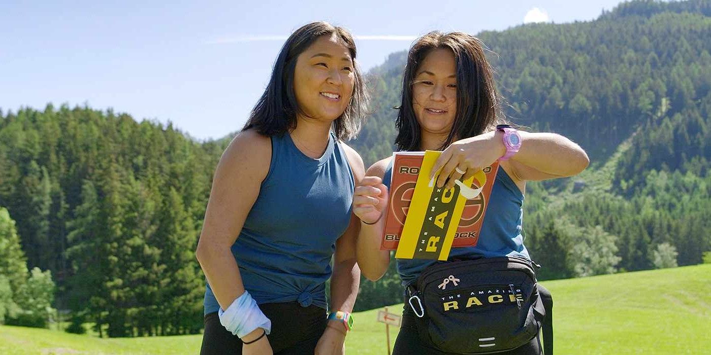 Emily Bushnell and Molly Sinert from The Amazing Race 34 smiling and opening up the roadblock envelope.