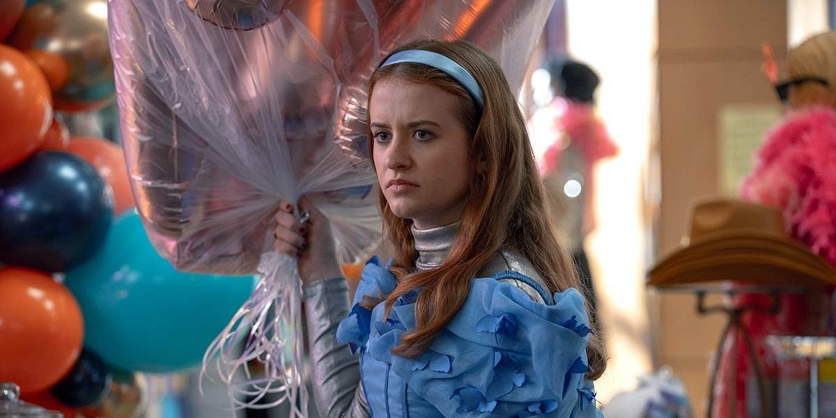 Jen in a Blue Dress Holding Balloons in Extraordinary