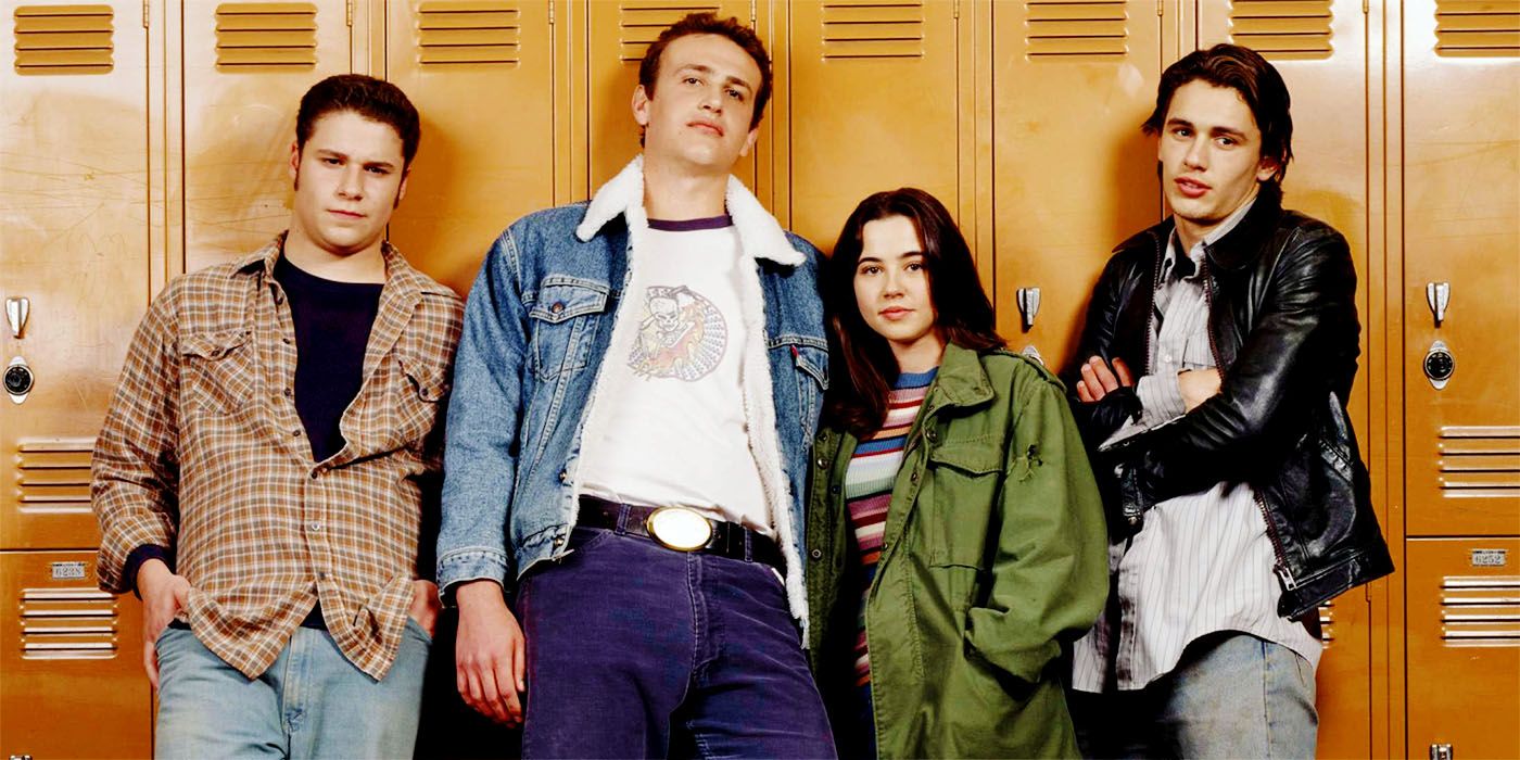 Freaks and Geeks cast members Seth Rogen, Jason Segel, Linda Cardellini, and James Franco against a row of lockers.