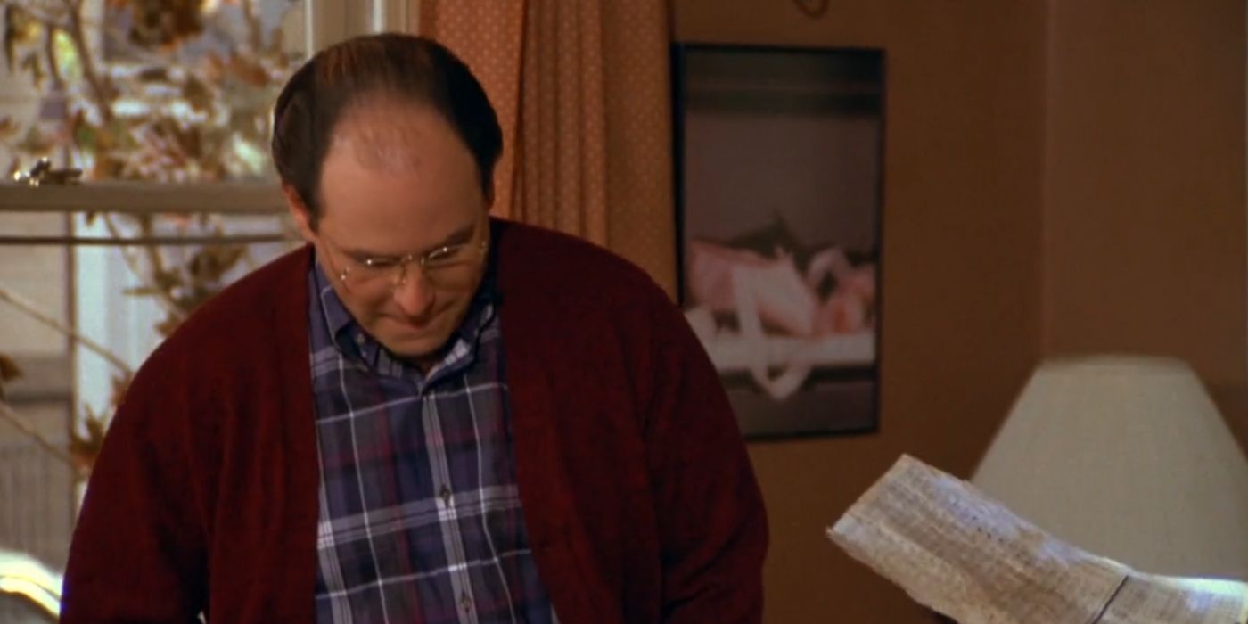 George Costanza olha para baixo enquanto Monica segura seu teste de QI em Seinfeld.