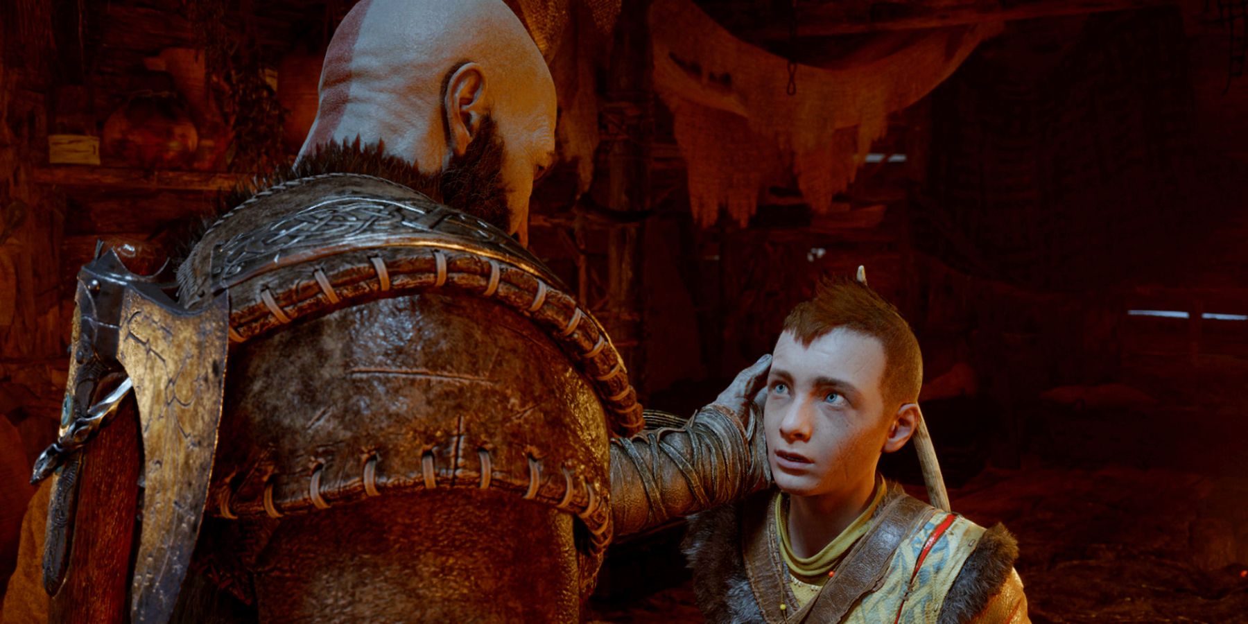 Kratos touching Atreus' face as he talks to his son in their home in Midgard in God of War Ragnarok.