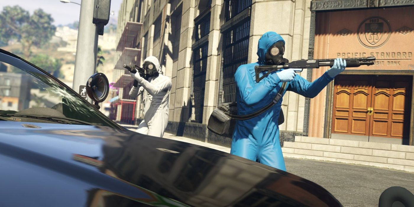 Two GTA Online players emerge from a bank in hazmat suits - one blue, the other white. One is wielding a shotgun while the other is firing a suppressed assault rifle.