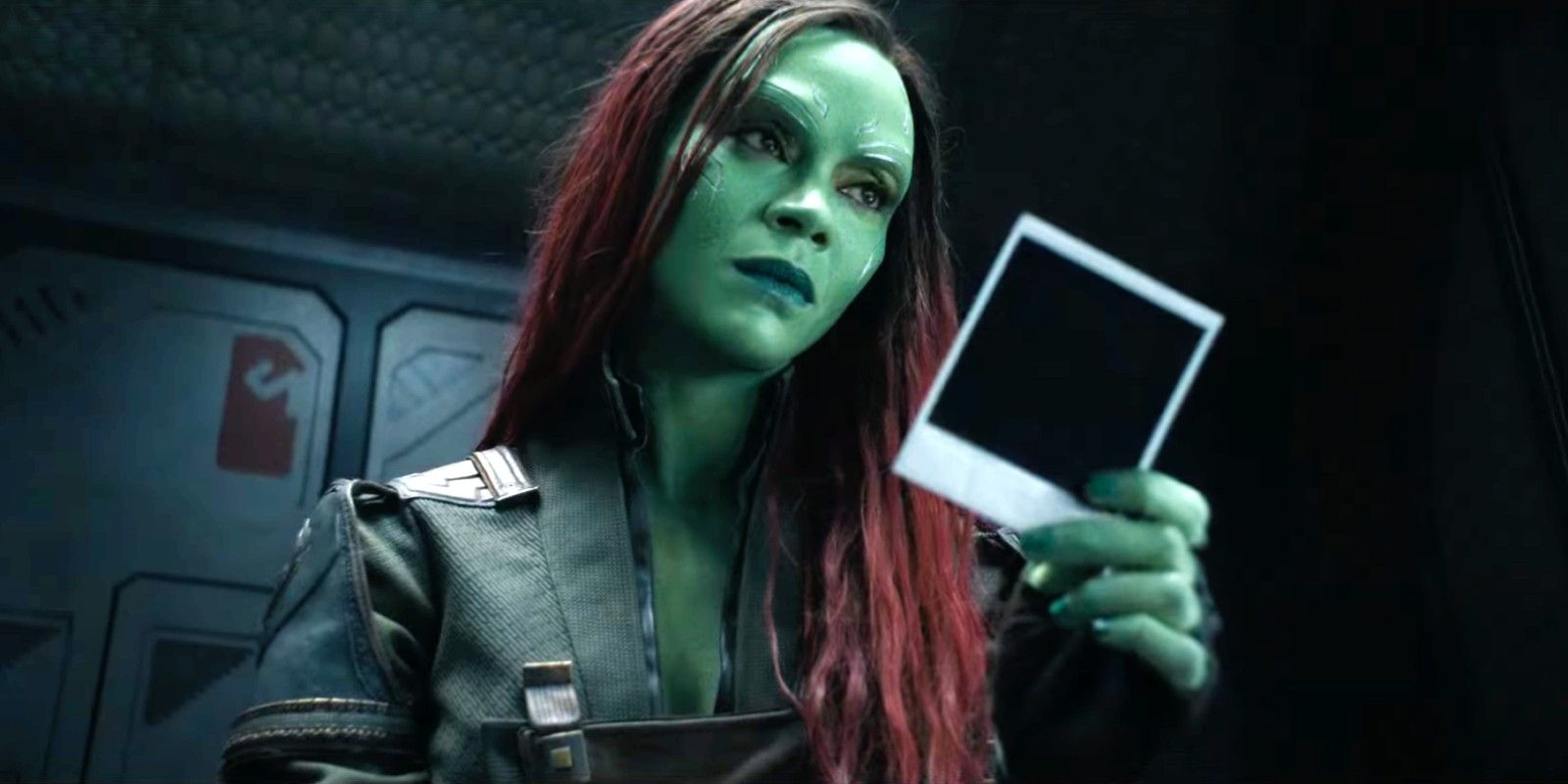 Zoe Saldaña as Gamora looking at an old picture in Guardians of the Galaxy Vol. 3