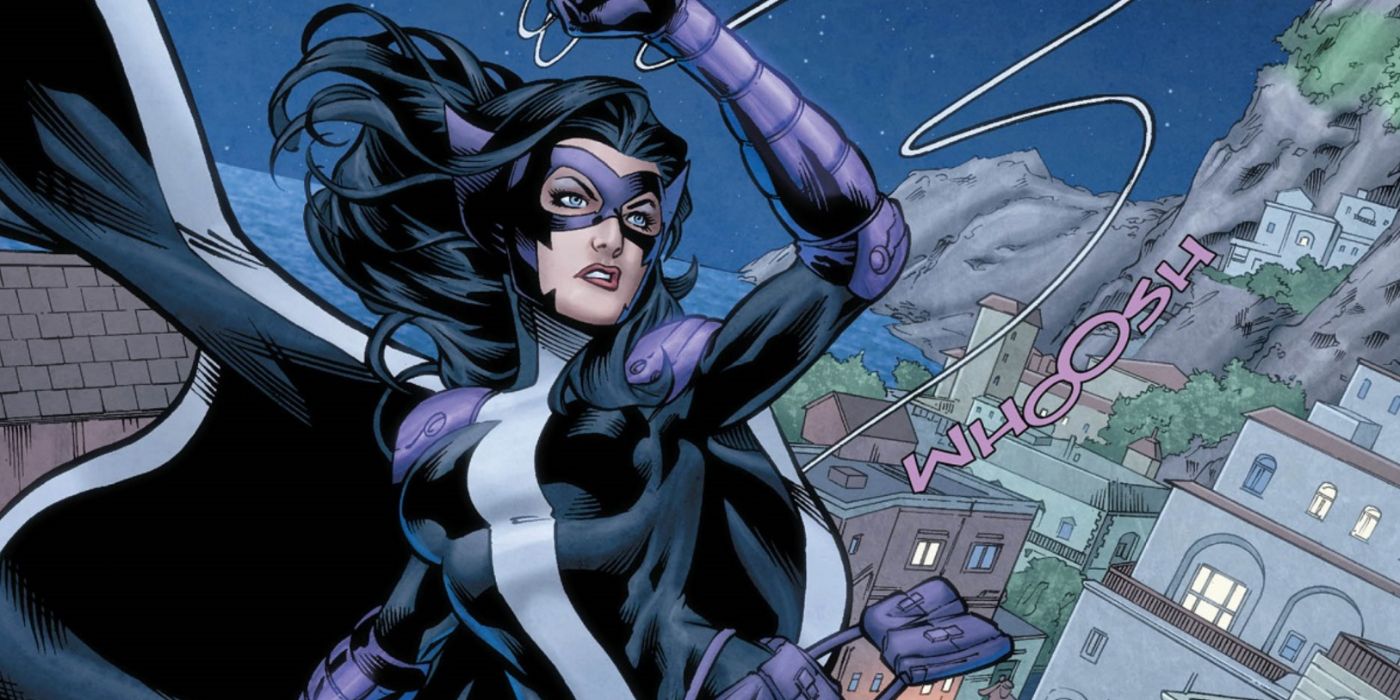 Huntress swinging through Gotham on her grappling line in DC Comics.