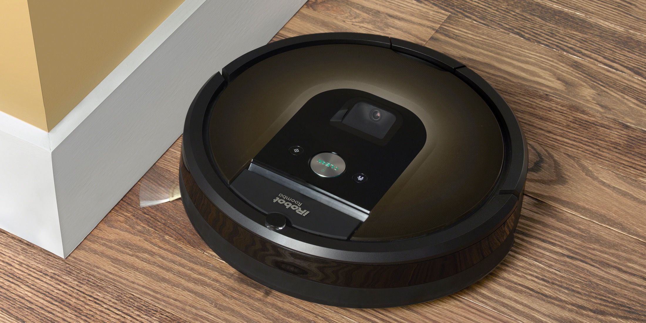 A robotic vaccum cleaner made by iRobot lying on the floor. 