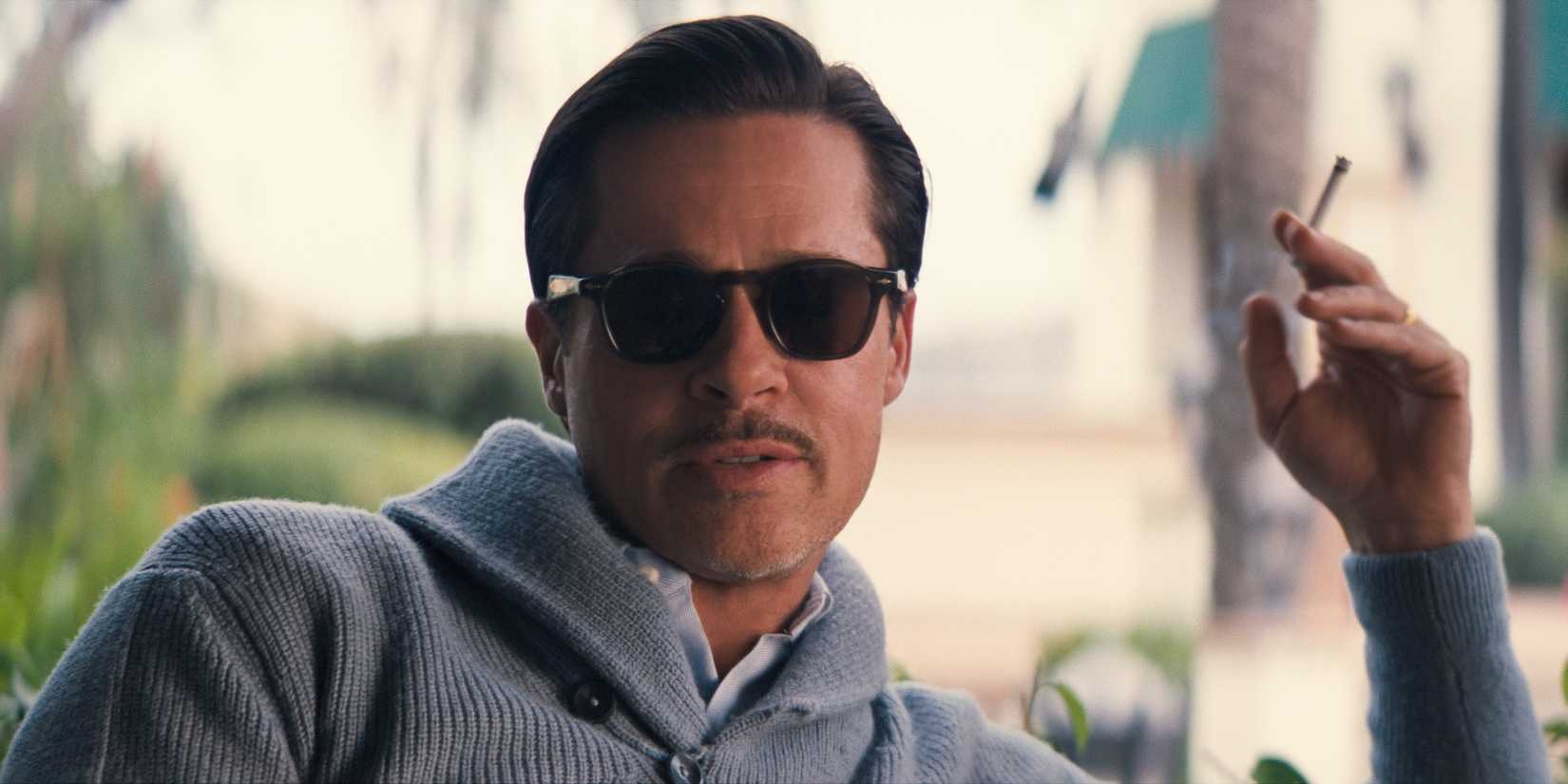 Jack Conrad (Brad Pitt) sitting outside his home with a cigarette in Babylon.
