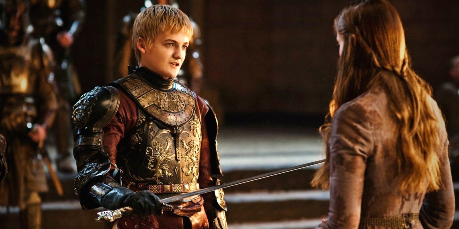 Jack Gleeson as Joffrey holding a sword out for Sansa to kiss on Game of Thrones