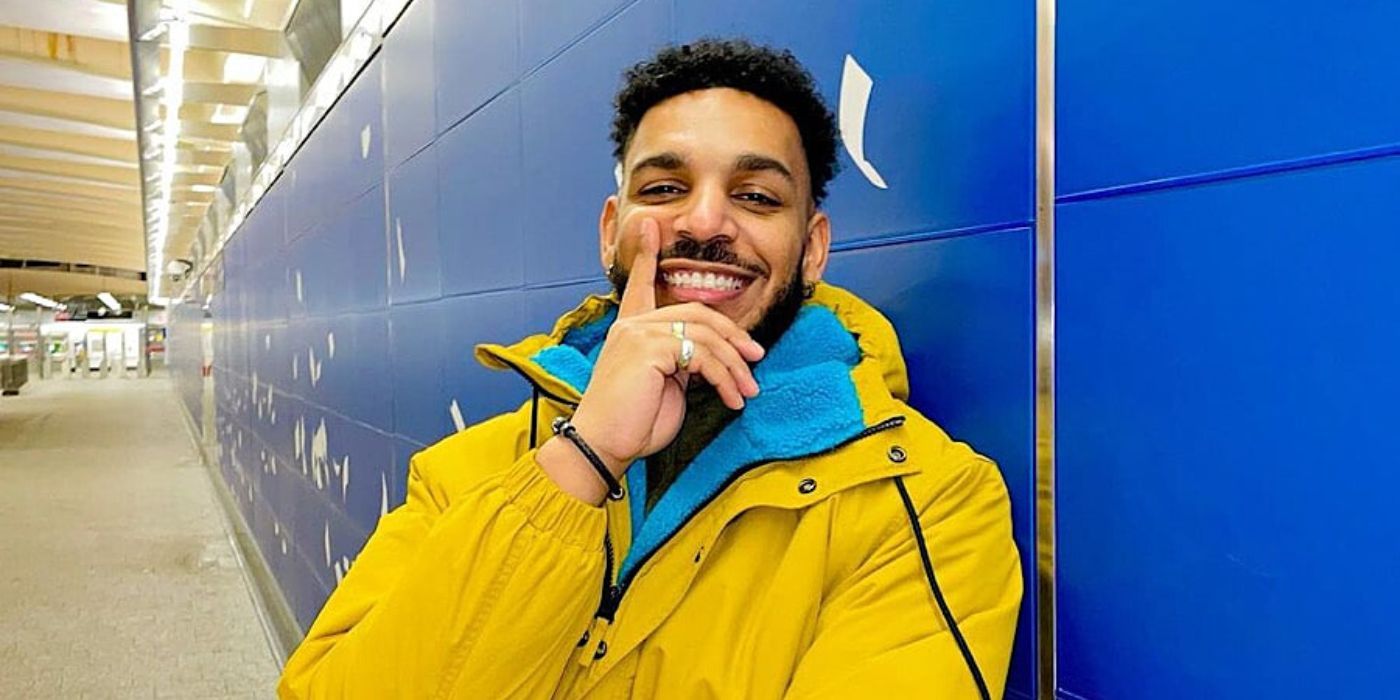 90 Day Fiancé star Jamal Menzies wearing yellow jacket and smiling
