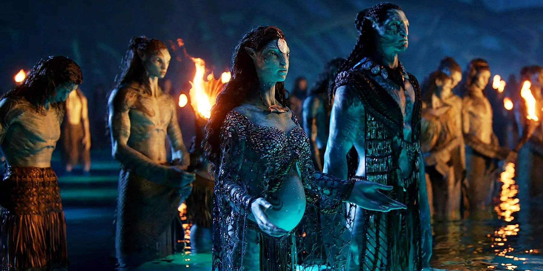 Kate Winslet as Ronal standing in water with hands raised in Avatar The Way of Water