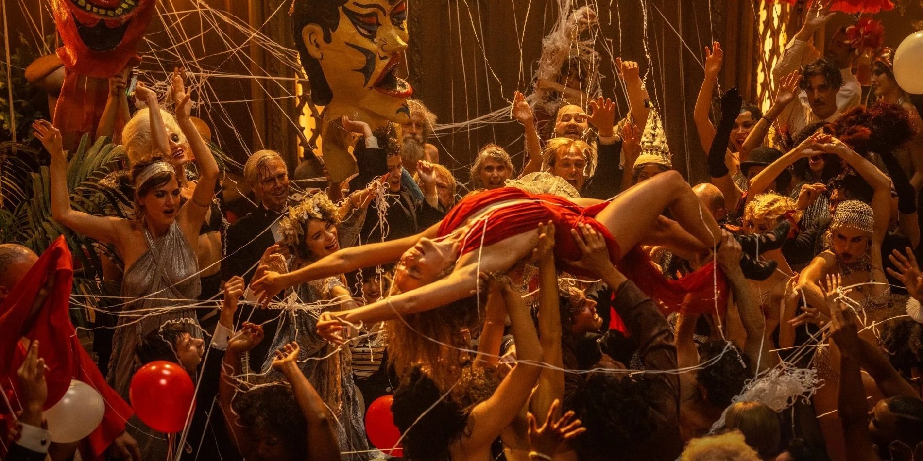 Margot Robbie as Nellie LaRoy in Babylon held above crowd at party