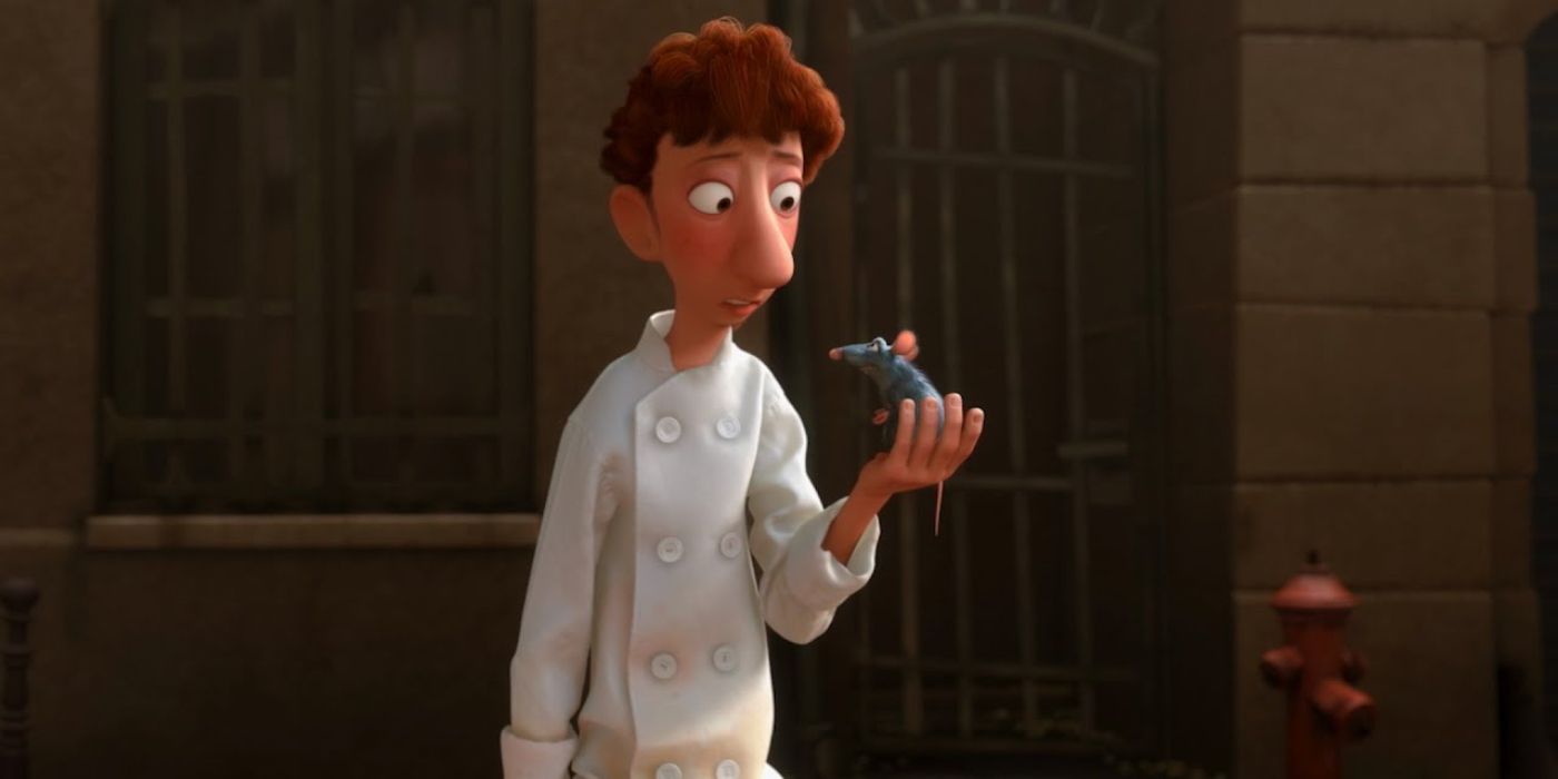 Linguini talks to Remy, holding him in his hand, in Ratatouille