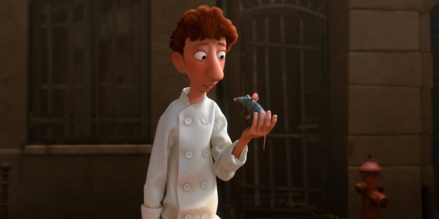 Linguini parle à Rémy, le tenant dans sa main, dans Ratatouille