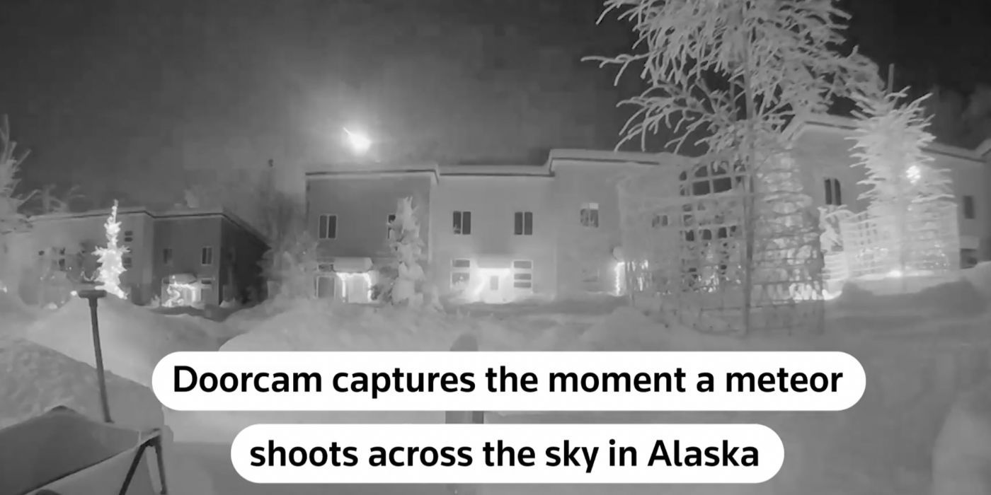 Screenshot from video showing meteor in residential neighborhood. Caption says 'Doorcam captures the moment a meteor shoots across the sky in Alaska'