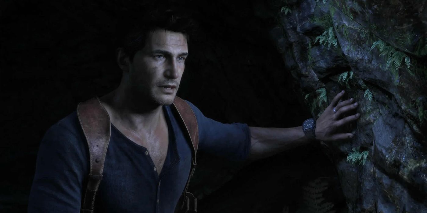 Nathan Drake emerges from a dark cave in Uncharted 4