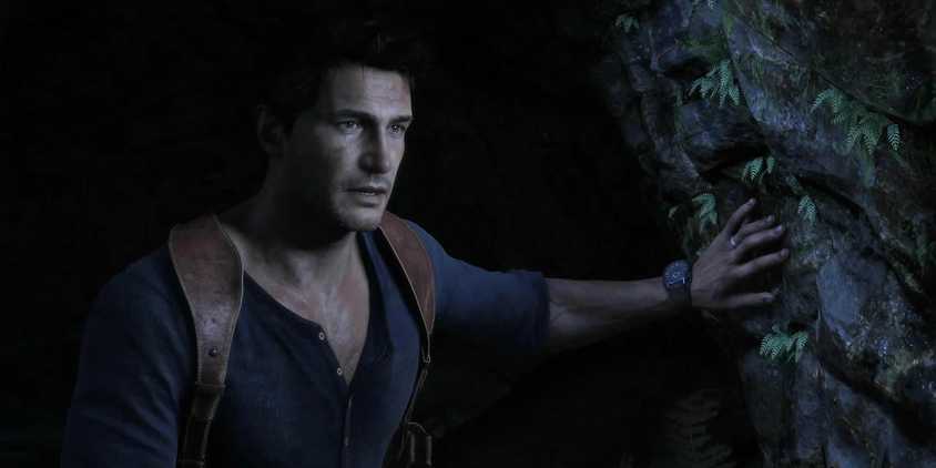 Nathan Drake emerges from a dark cave in Uncharted 4