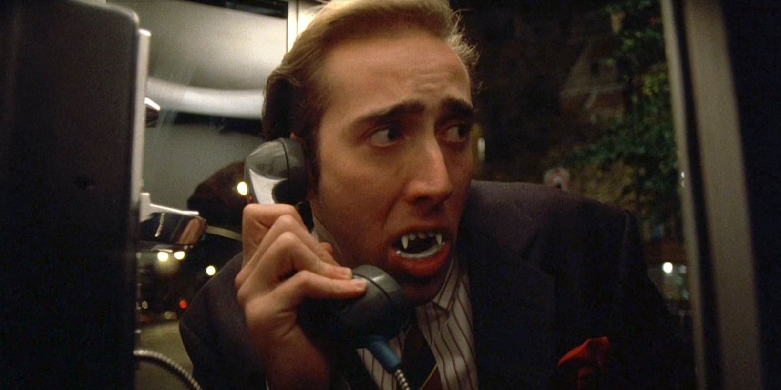 Nicolas Cage as Peter Loew wearing fake vampire teeth in Vampire's Kiss