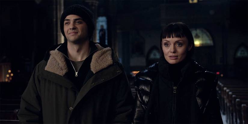 Owen (Noah Centineo) and Max (Laura Haddock) in a church in The Recruit