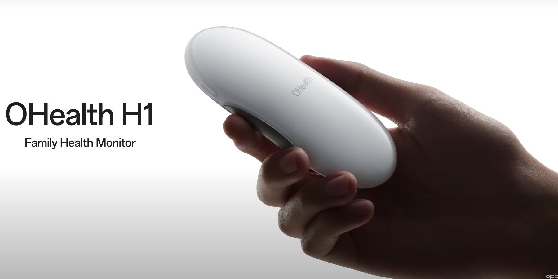A hand holding the Oppo OHealth H1 Family Monitor