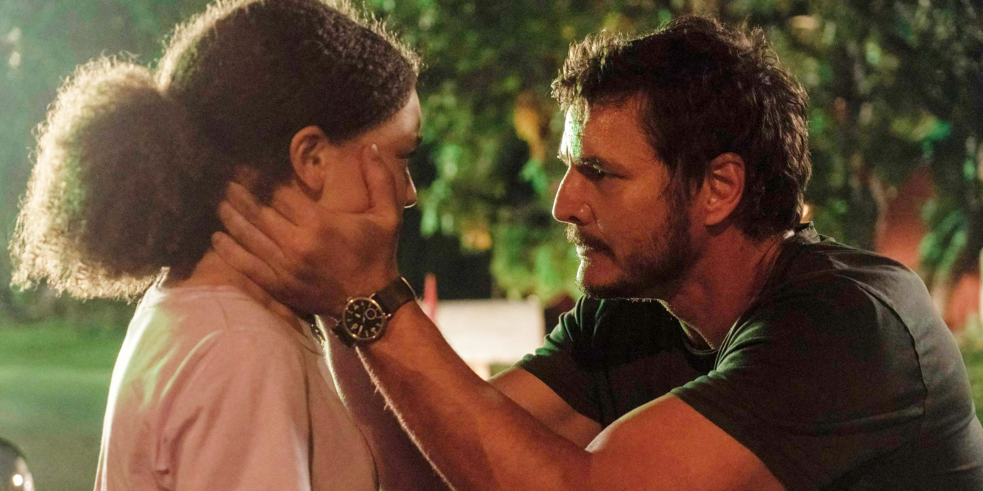 Pedro Pascal as Joel blocks the face of Nico Parker as Sarah in The Last of Us
