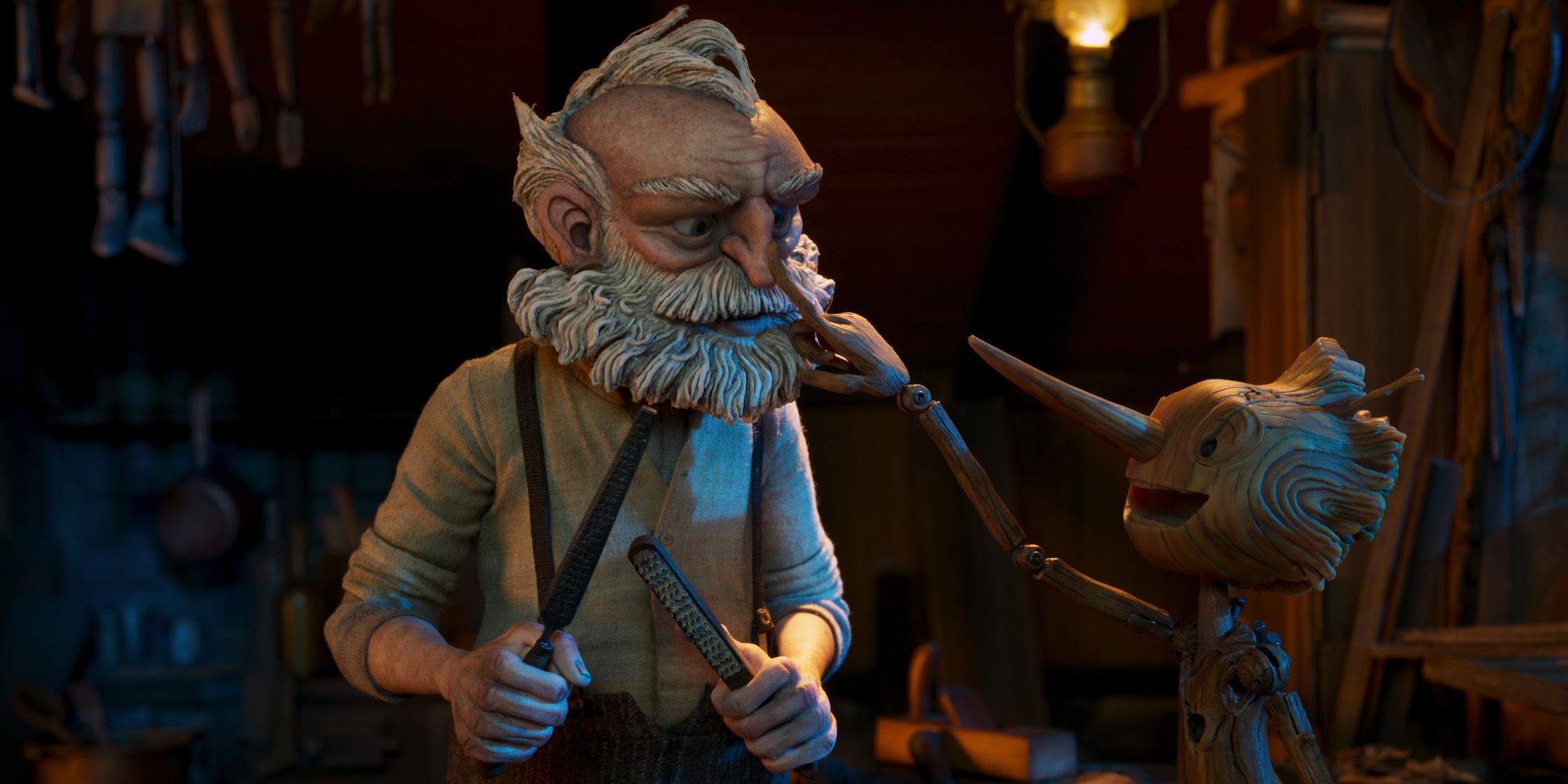 Pinocchio pokes Geppetto on the nose in Guillermo del Toro's Pinocchio.