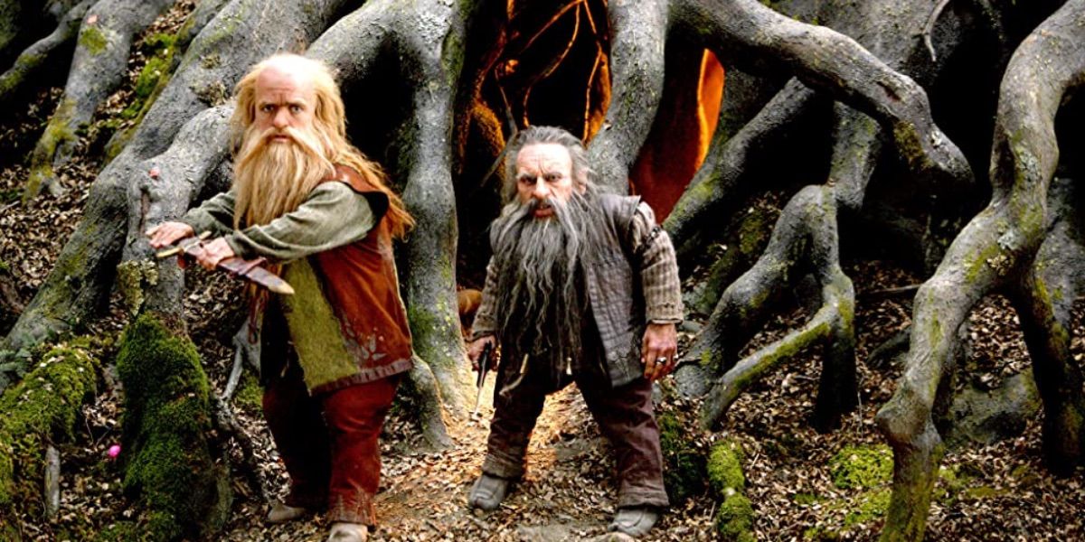 Two dwarves stand cautiously in front of a tree house in Chronicles of Narnia Prince Caspian