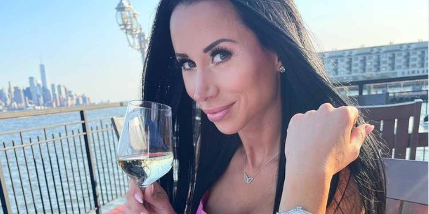 RHONJ's Rachel Fuda holding a glass of white wwine