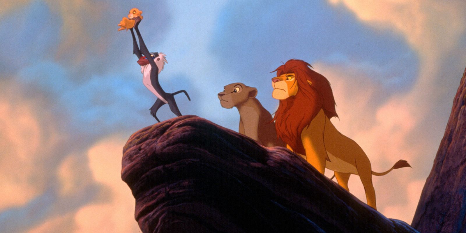 Rafiki hold Simba after the ceremony in the Lion King