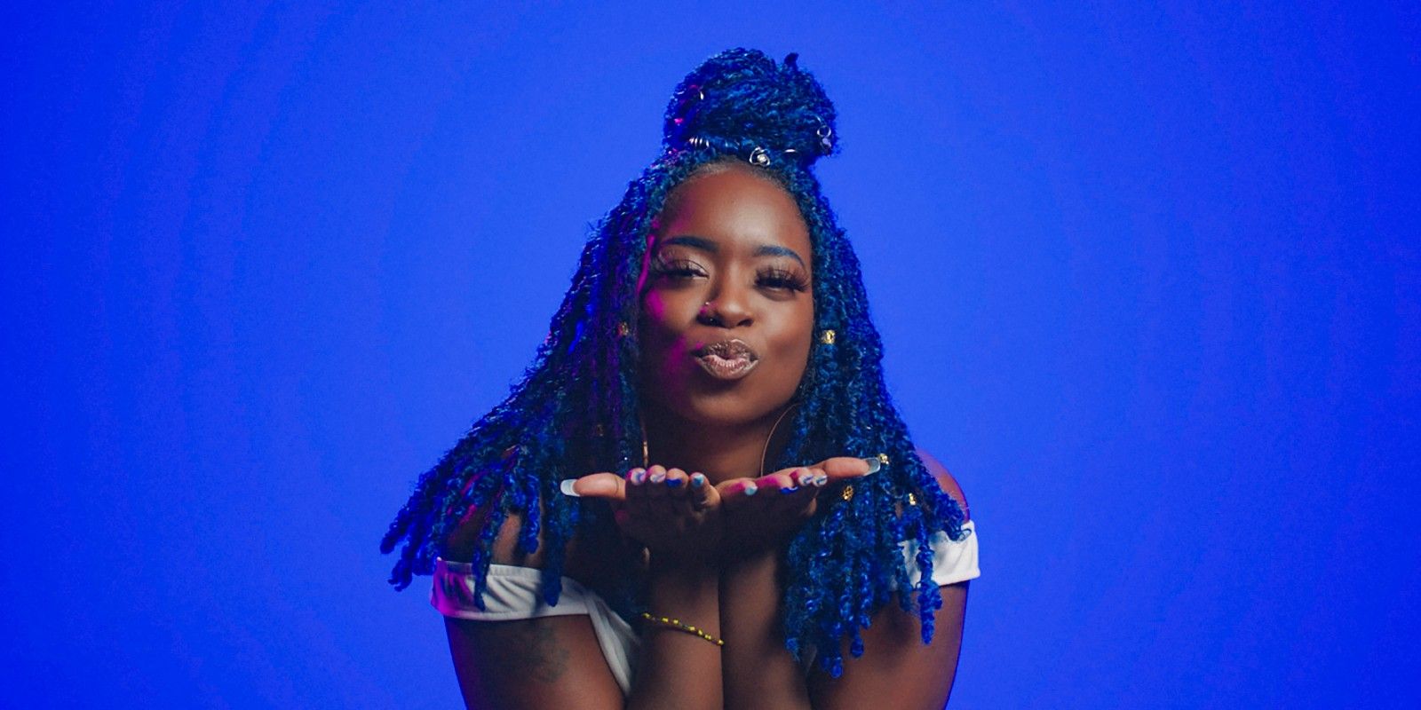 Raven Sutton blow a kiss toward the camera in a promotional image for The Circle Season 5.