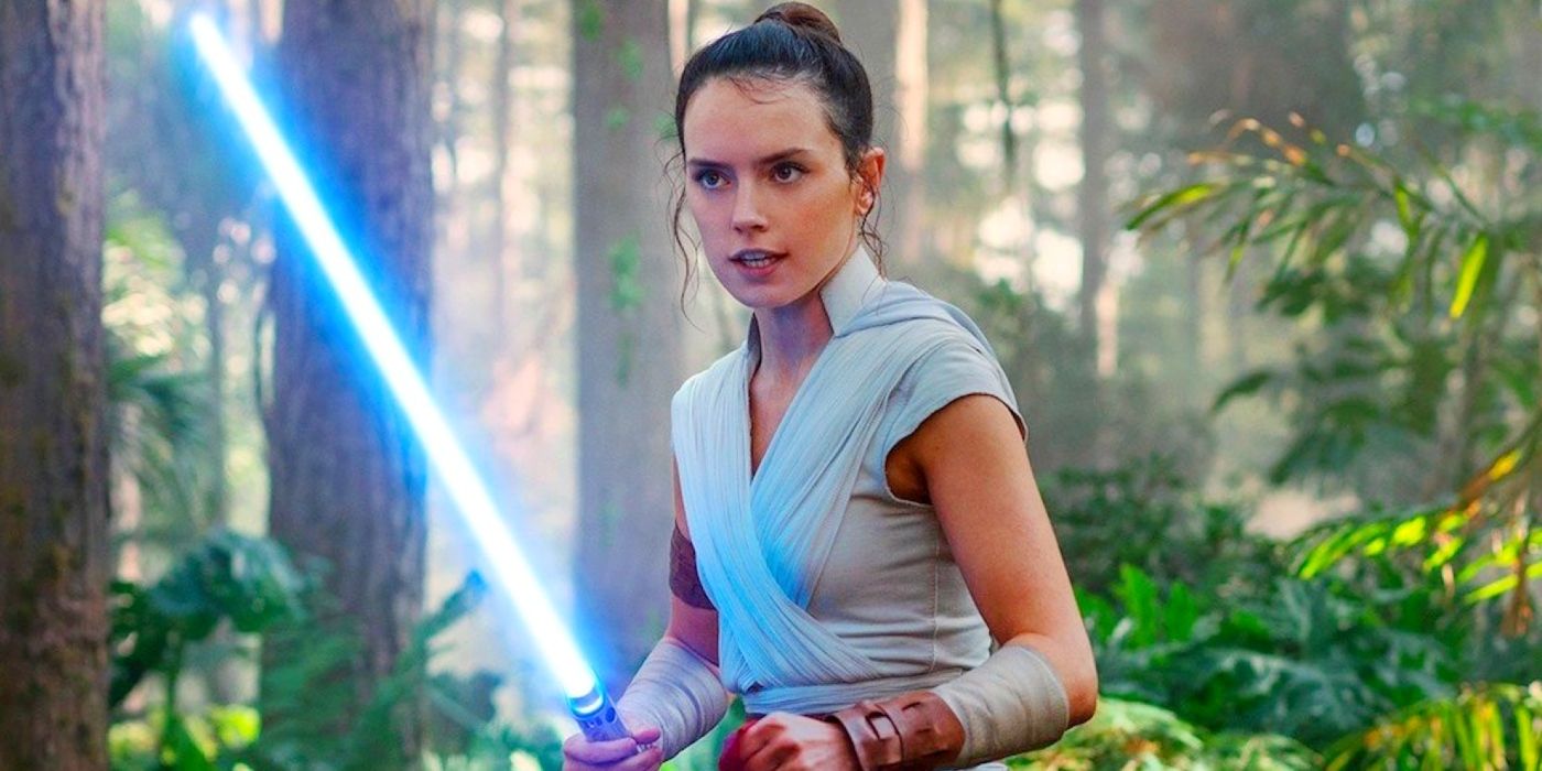 Daisy Ridley as Rey holding her lightsaber in Star Wars: The Rise Of Skywalker.