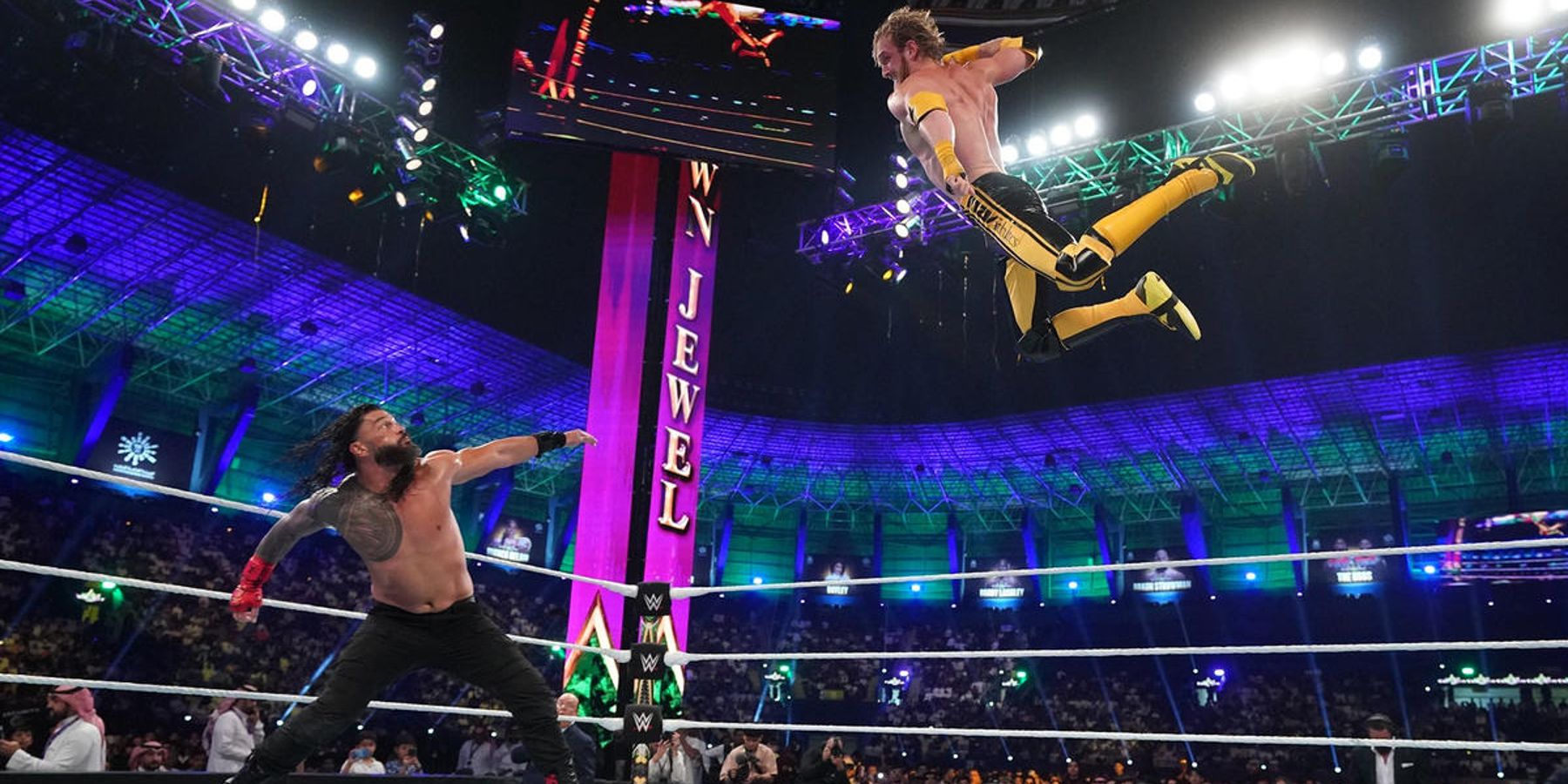 Roman Reigns prepares to superman punch Logan Paul as he soars through the air at WWE Crown Jewel in 2022.