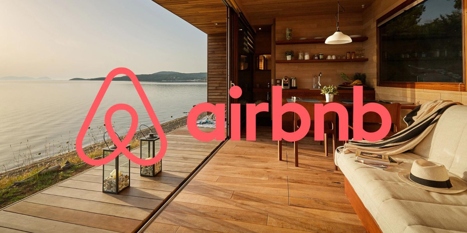 Airbnb logo in front of a house