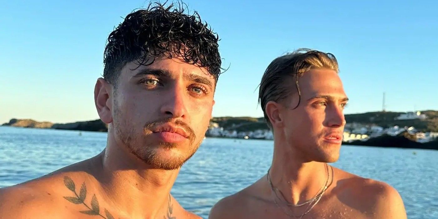 Seb Melrose looking at the camera and Creed McKinnon looking off in the distance from Too Hot To Handle season 4 in front of blue water.