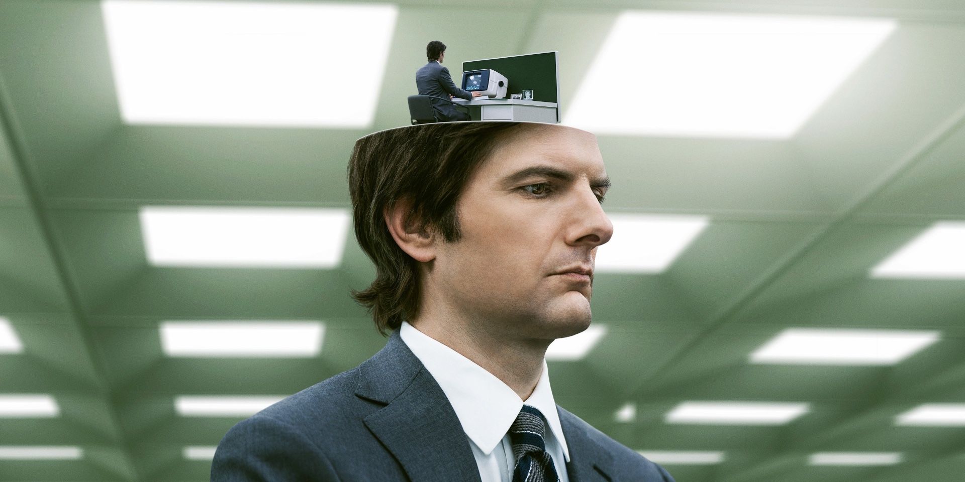 Adam Scott as Mark in Severance whose head is opening to show himself at a desk